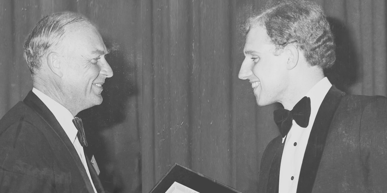 Marc Gough, on the right, shaking hands as he receives an award, in an old black and white photograph