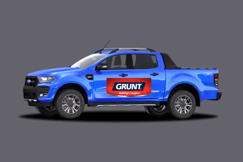 A blue utility vehicle with GRUNT branding